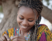 Woman with braided hair representing the traditional Chebe hair care practice in Chad